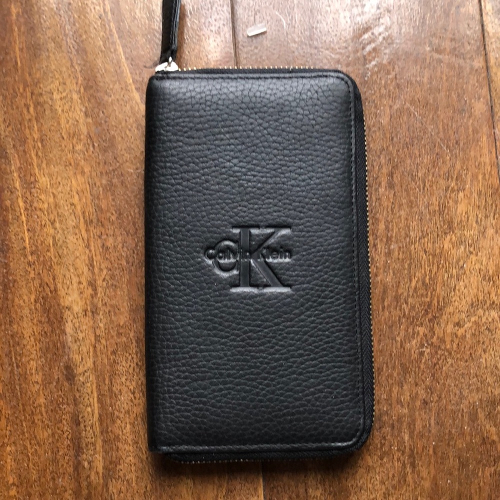 Calvin Klein black leather wallet w/ gold wrap around zipper. NWOT